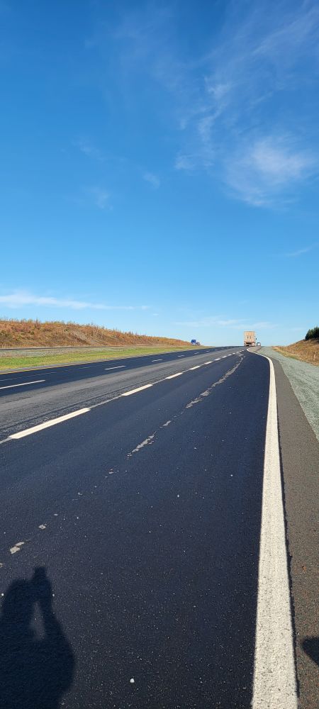 Road surface photographed looking back — high receiver grazing angle, bright appearance